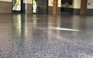 Beautiful high-gloss epoxy and polyaspartic full-flake flooring atop an outdoor concrete space.